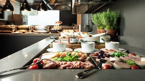 A buffet table with various food items and utensils. - KPM Hotel & Residences Berlin, a Member of Design Hotels (Berlin)