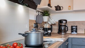 A modern kitchen with stainless steel appliances, a wooden countertop, and a pot on the stove. - Triumph in der Heide (Buchholz (Aller))