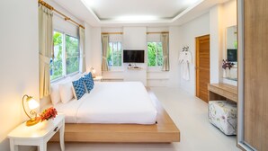 A modern bedroom with a large bed, bedside tables, a TV, and a wardrobe. - Blu Marine Hua Hin Resort and Villas (Hua Hin)