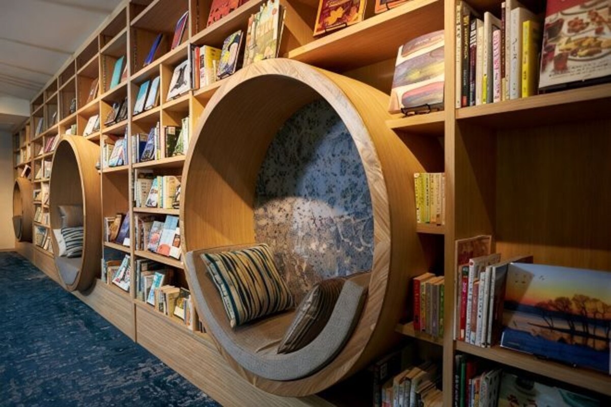 A library with bookshelves and circular reading nooks.
