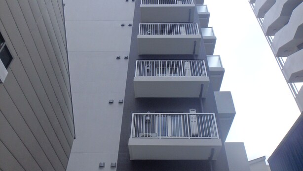 A multi-story building with balconies, a visible entrance, and a modern architectural design. - YADO at Tennouji Namba ExTen (Osaka)