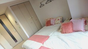 A bedroom with a bed, pillows, and a wardrobe. - YADO at Tennouji Namba ExTen (Osaka)
