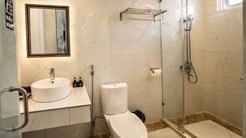 A bathroom with a sink, toilet, and shower.