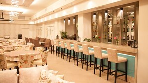 A hotel lobby with a bar area, seating arrangements, and a reception desk. - Hotel Kanali (Preveza)