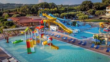 A water park with multiple slides and a swimming pool.
