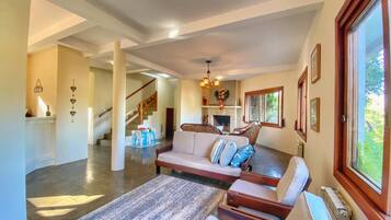 Quarto família, várias camas, vista para o jardim | Área de estar | TV LED