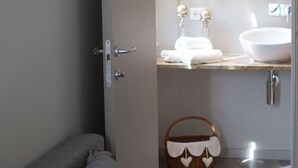 A bathroom with a white sink, a gold-framed mirror, and a basket with heart-shaped decorations. - Il Genovino (Genoa)