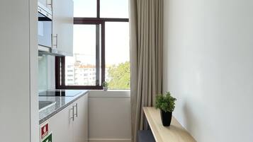 A small kitchen with a window, a table, and a bench.