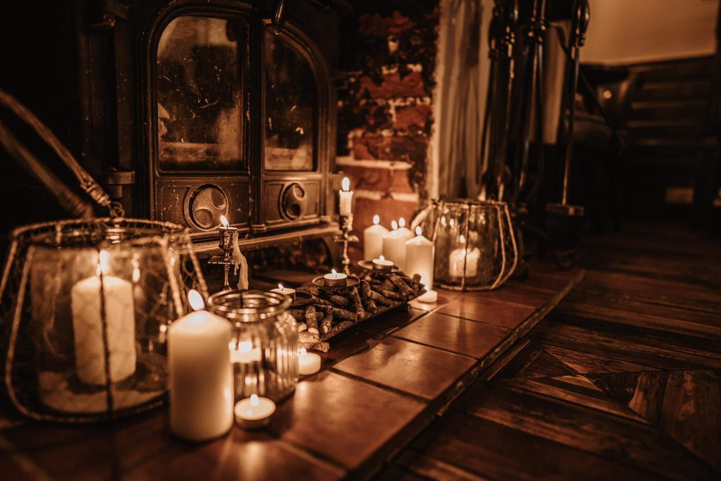 A wooden table with candles and a vintage radio.