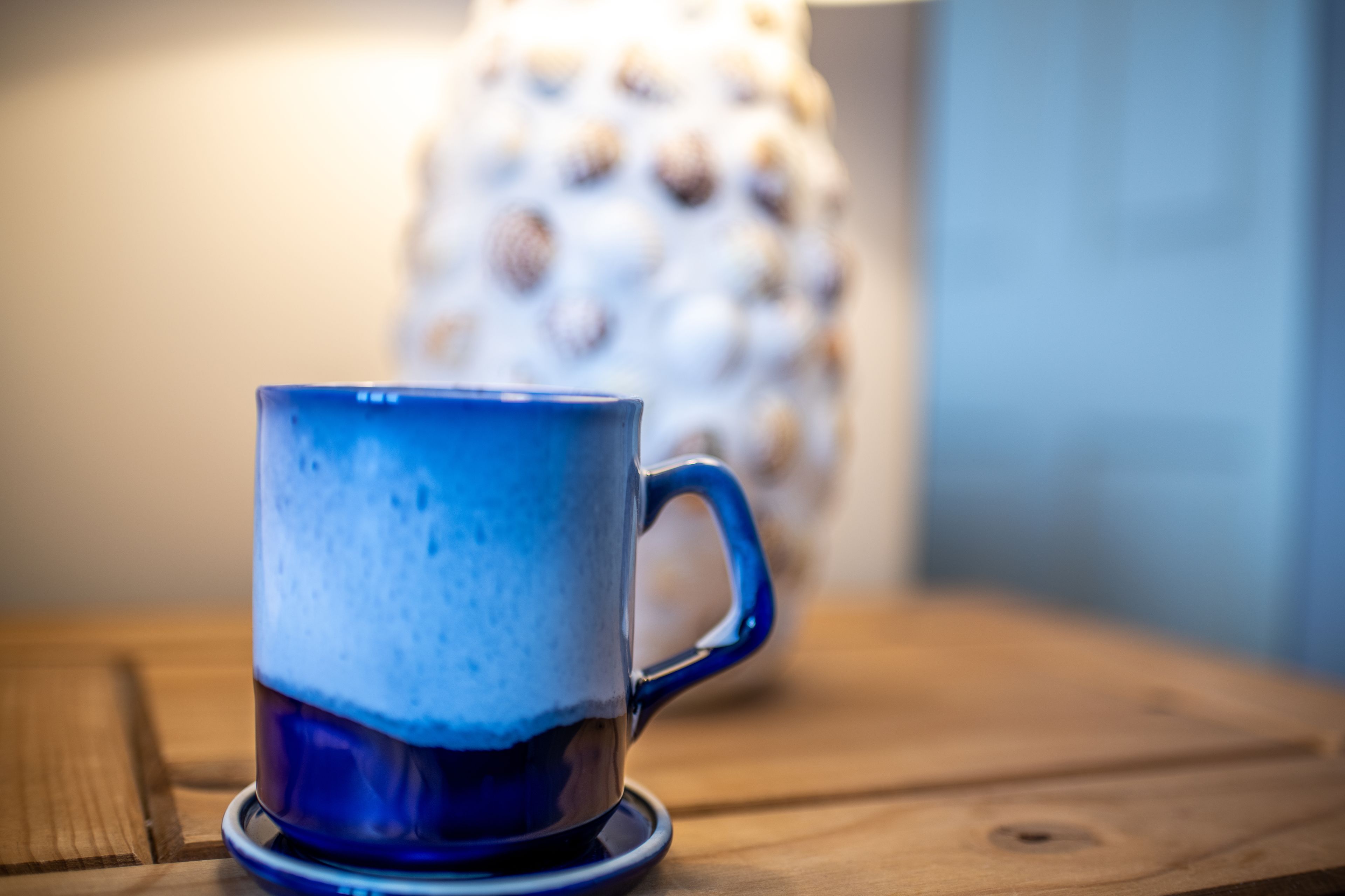 A blue ceramic mug on a wooden table.