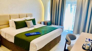 A hotel room with a bed, a desk, and a chair.