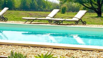 Seasonal outdoor pool, open 8:00 AM to 10:00 PM, pool loungers