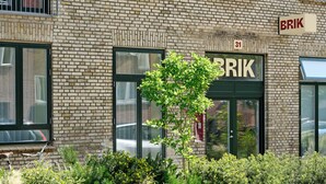 A brick building with a sign reading "BRIK" and the number "31" above the entrance. - BRIK Apartment Hotel (Copenhagen)