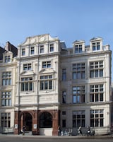 A historic building with a sign indicating dining rooms.