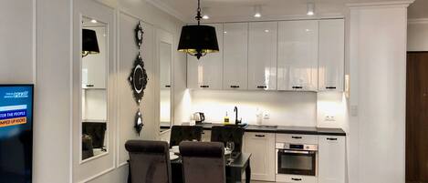 Deluxe Apartment, 1 King Bed with Sofa bed, Courtyard View | Living area | Flat-screen TV