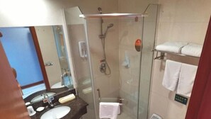 A compact bathroom with a glass-enclosed shower, a sink, and a toilet. - GreenTree Inn Chongqing Longhu Times Tianjie Xietaizi Subway Station Hotel (Chongqing)