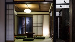 A traditional Japanese room with tatami flooring, a low table, and shoji screens. - Gojo Samurai Machiya, Gojo Samurai Machiya (Kyoto)