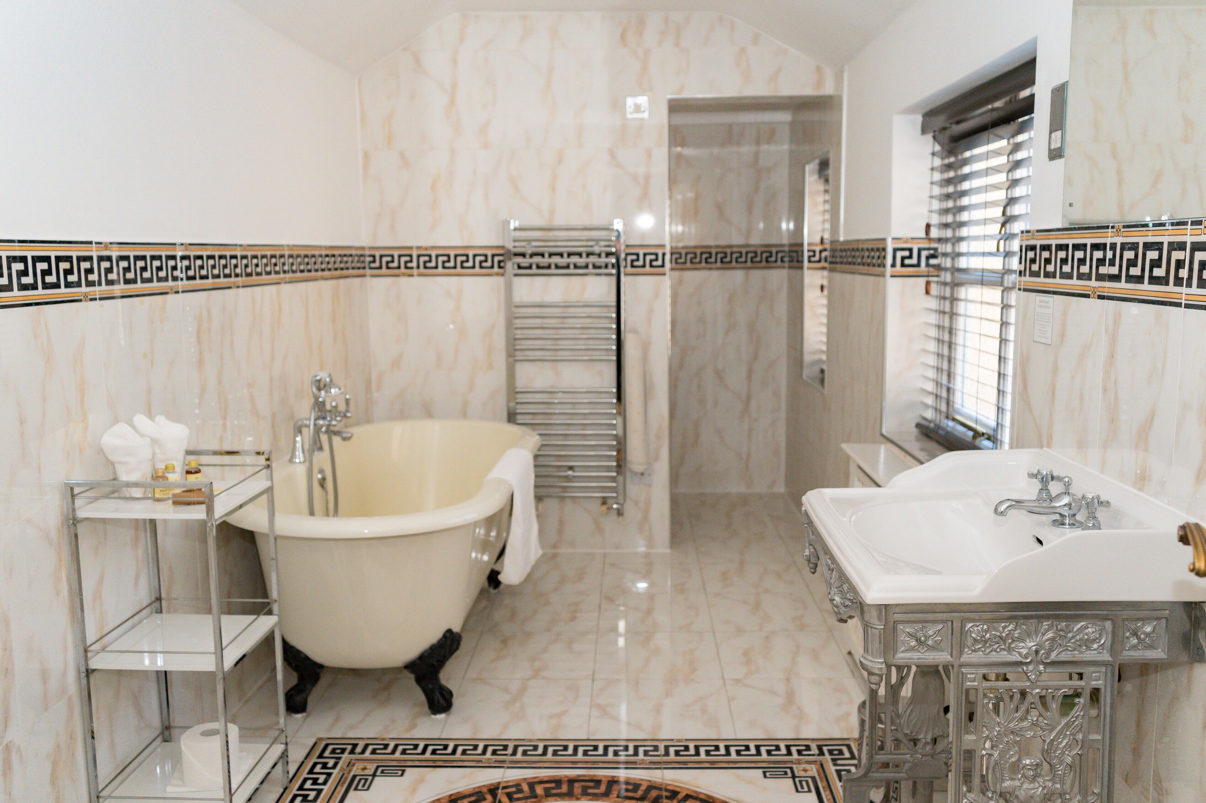A bathroom with a freestanding bathtub, a vanity with a sink, and a toilet.