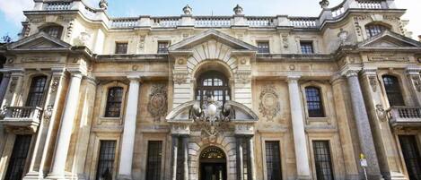 A grand, classical building with symmetrical architecture, large columns, and ornate decorations.
