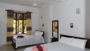 A hotel room with two beds, a ceiling fan, and a window with curtains. - Eco Villa - Sinharaja (Deniyaya)