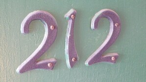 Three purple numbers '2', '1', and '2' on a green background. - Spruce Pine Inn (Spruce Pine)