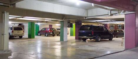 A multi-level parking garage with several cars parked.