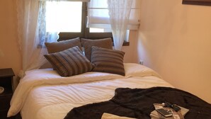A bedroom with a bed, pillows, a tray with cups and a book, and a window with sheer curtains. - Arahova Cozy Apartment (Distomo-Arachova-Antikyra)