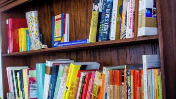 A wooden bookshelf filled with various books.
