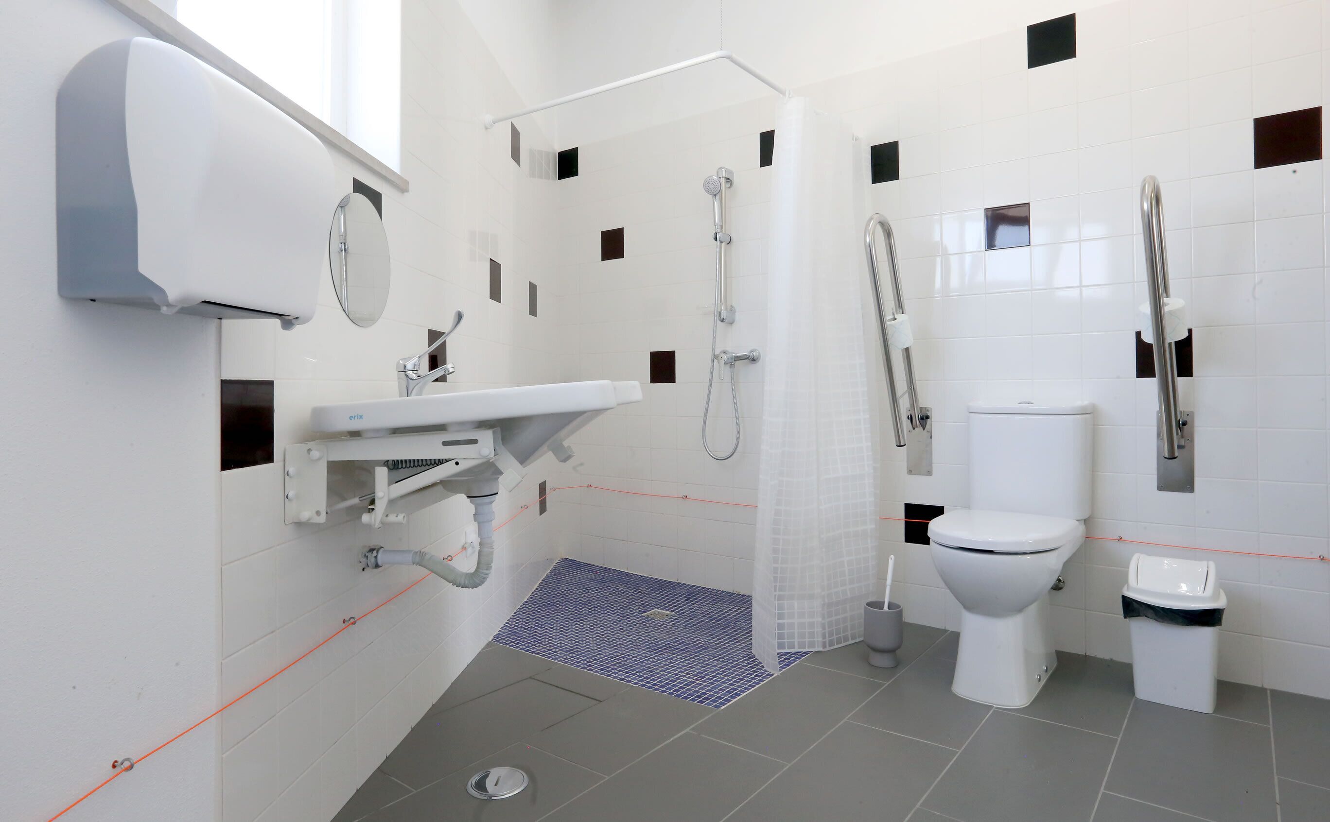 A modern bathroom with a toilet, bidet, and shower.
