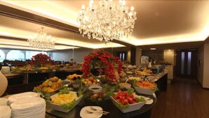 A buffet with various food items and a chandelier.