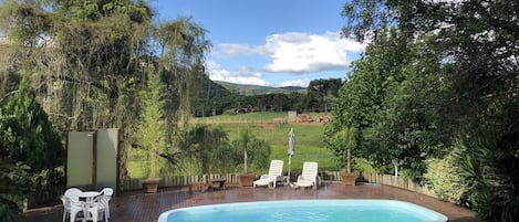 Una piscina cubierta, una piscina al aire libre, sombrillas, tumbonas