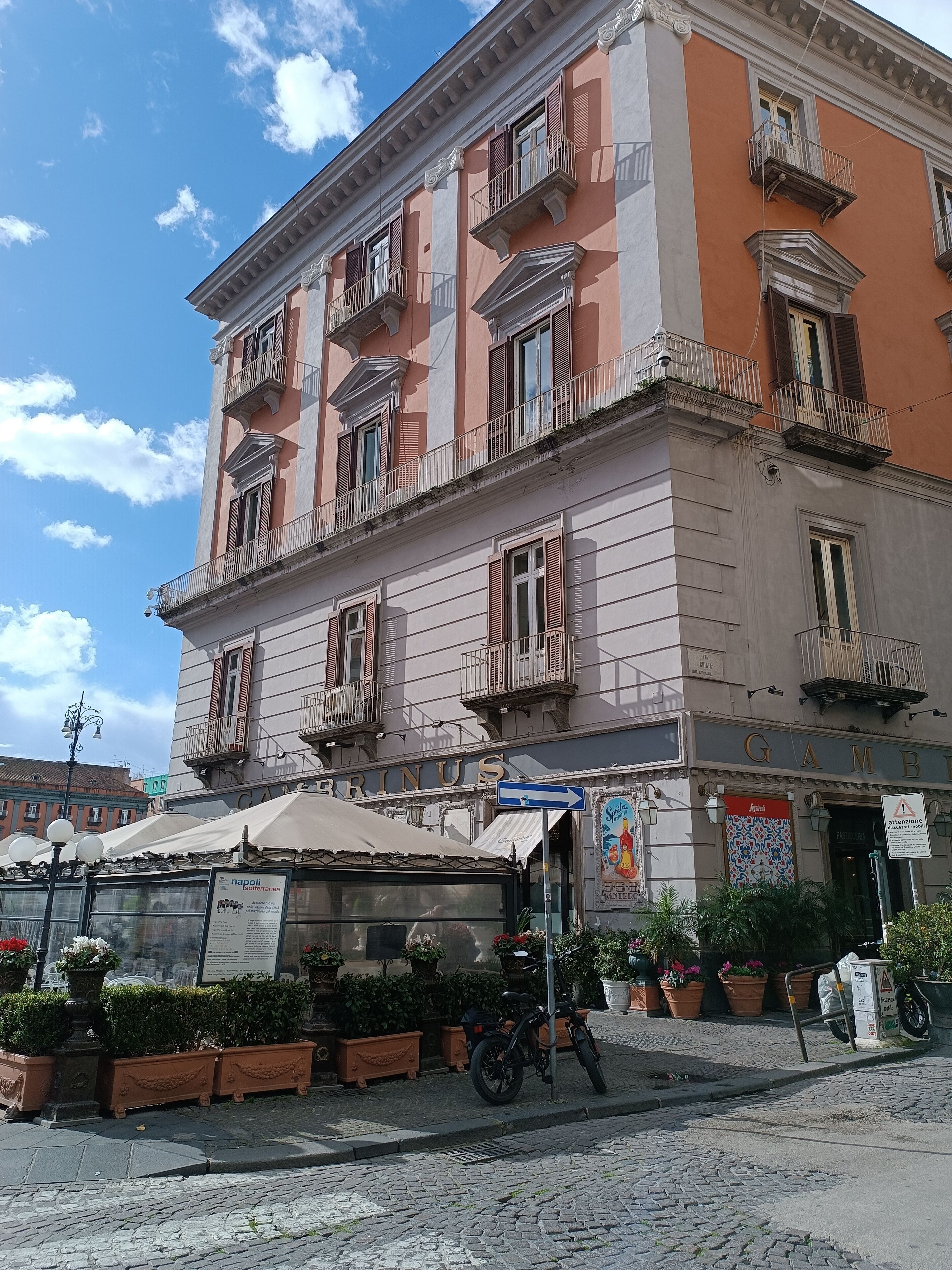 A historic building with multiple balconies and a sign reading "GAMBINI".