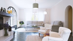 A living room with a sofa, armchairs, a coffee table, and a fireplace. - Villa Borgovecchio B&B (Camaiore)