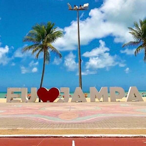 A beach with palm trees and a sign that reads "EUROAMPA".