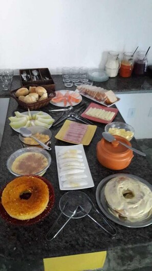 A kitchen counter with various food items and utensils.