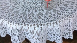 A table with a lace tablecloth, a white kettle, mason jars, and a woven basket. - Agro Guesthouse Korena (Tkibuli)