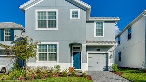 A two-story residential building with a blue door, white shutters, and a number 1655 on the front.