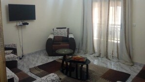 Apartment | Living area | Flat-screen TV - Residence Fatou Ndiaye (St. Louis)