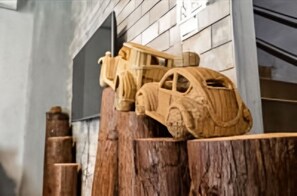A wooden sculpture of a car and a figure on a wooden structure. - l-stack B&B (Magong)