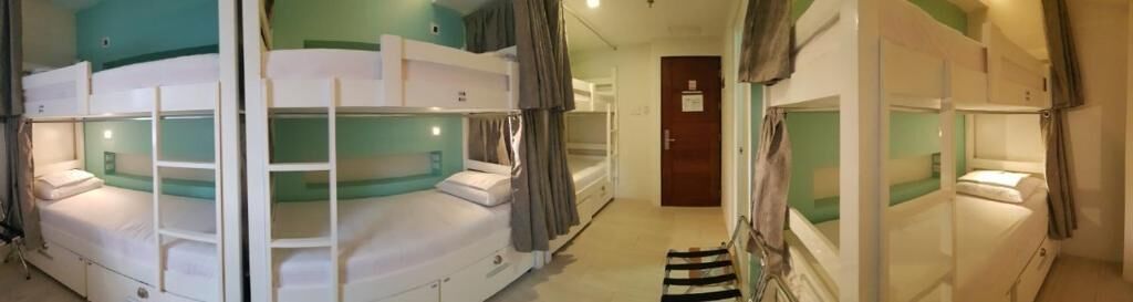 A bunk bed room with a door leading to another room.