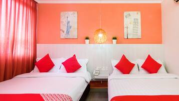 A hotel room with two beds, red and white bedding, a telephone, and two wall-mounted artworks.