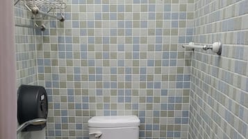A small bathroom with a toilet, sink, and a trash bin.