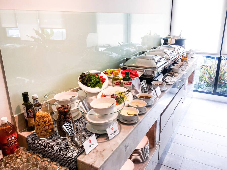 A buffet with various food items and condiments.