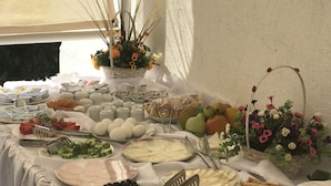 A buffet table with various food items and utensils. - Halikarnas Pansiyon (Bodrum)