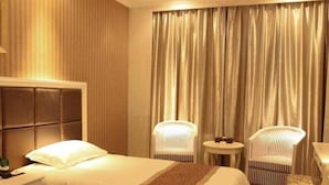 A hotel room with two beds, a small table, two chairs, and a large window with curtains. - Zhongdun Boutique Hotel (Hangzhou)