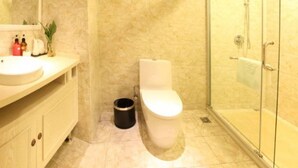 A bathroom with a marble sink, toilet, and a glass-enclosed shower. - Zhongdun Boutique Hotel (Hangzhou)