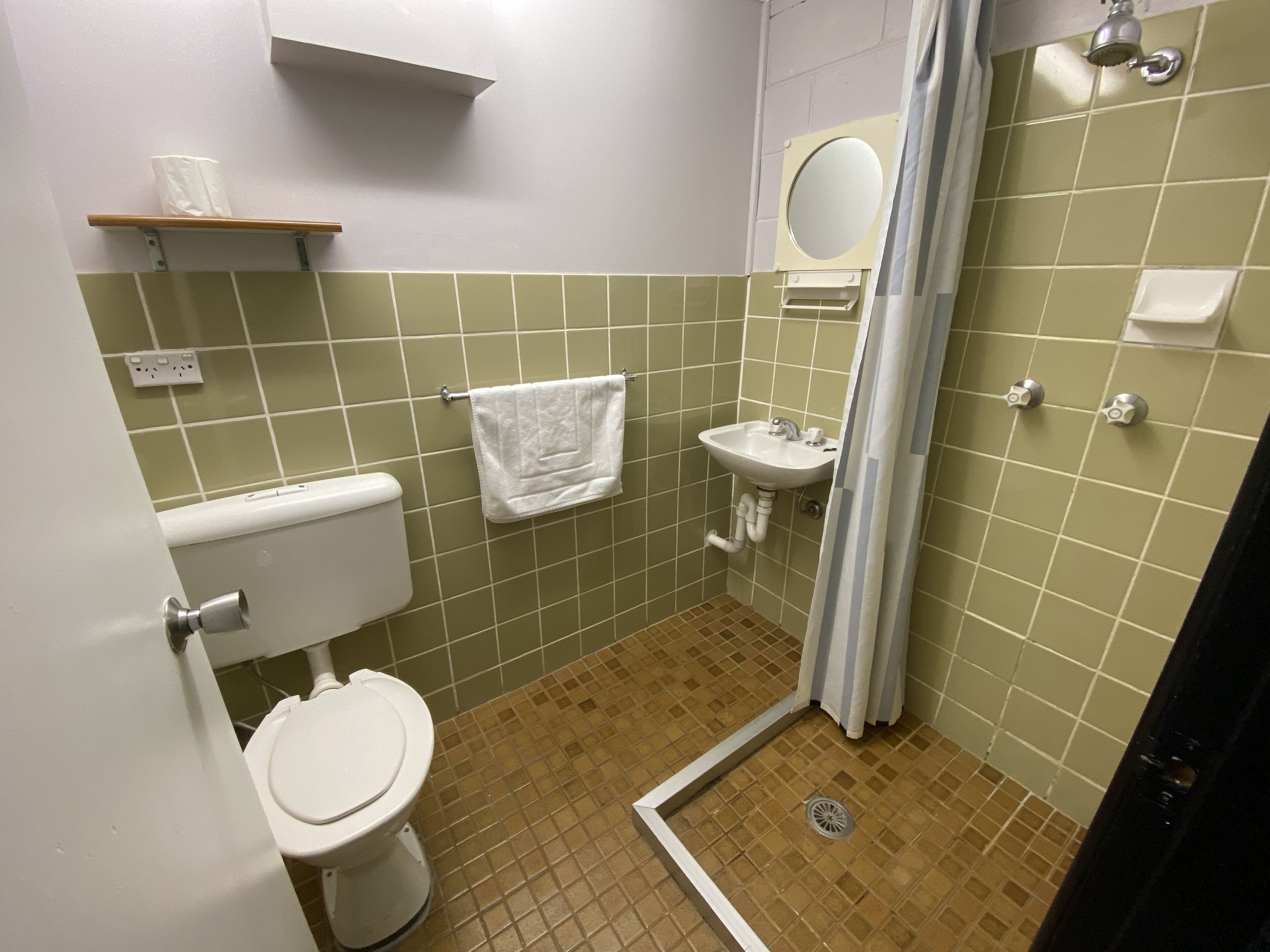 budget family room | bathroom | shower, hair dryer, towels, soap