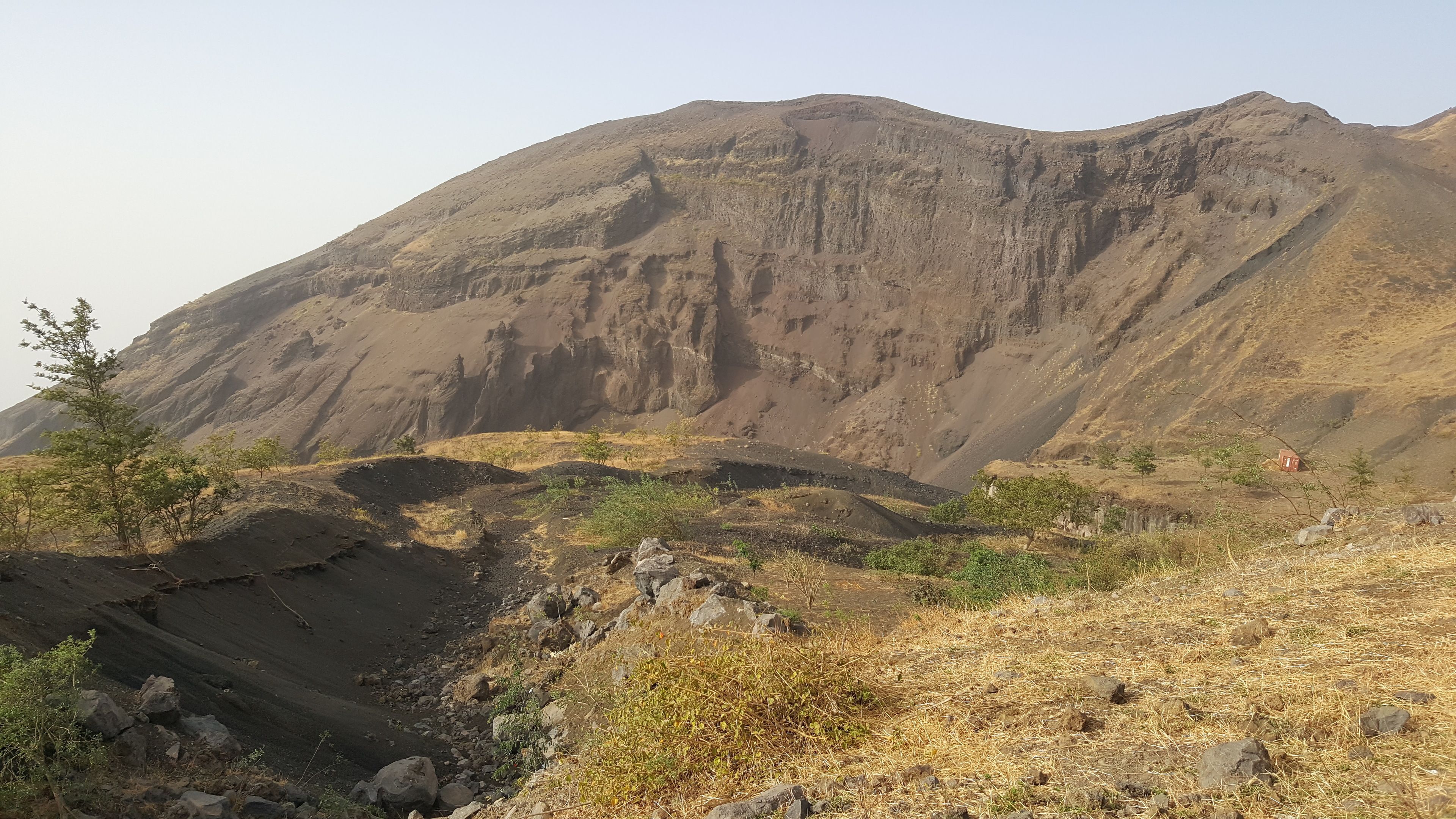 A mountainous landscape with rocky terrain and sparse vegetation.