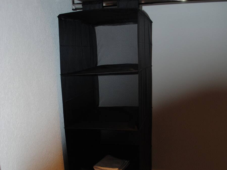 A corner storage unit with shelves and a cabinet.
