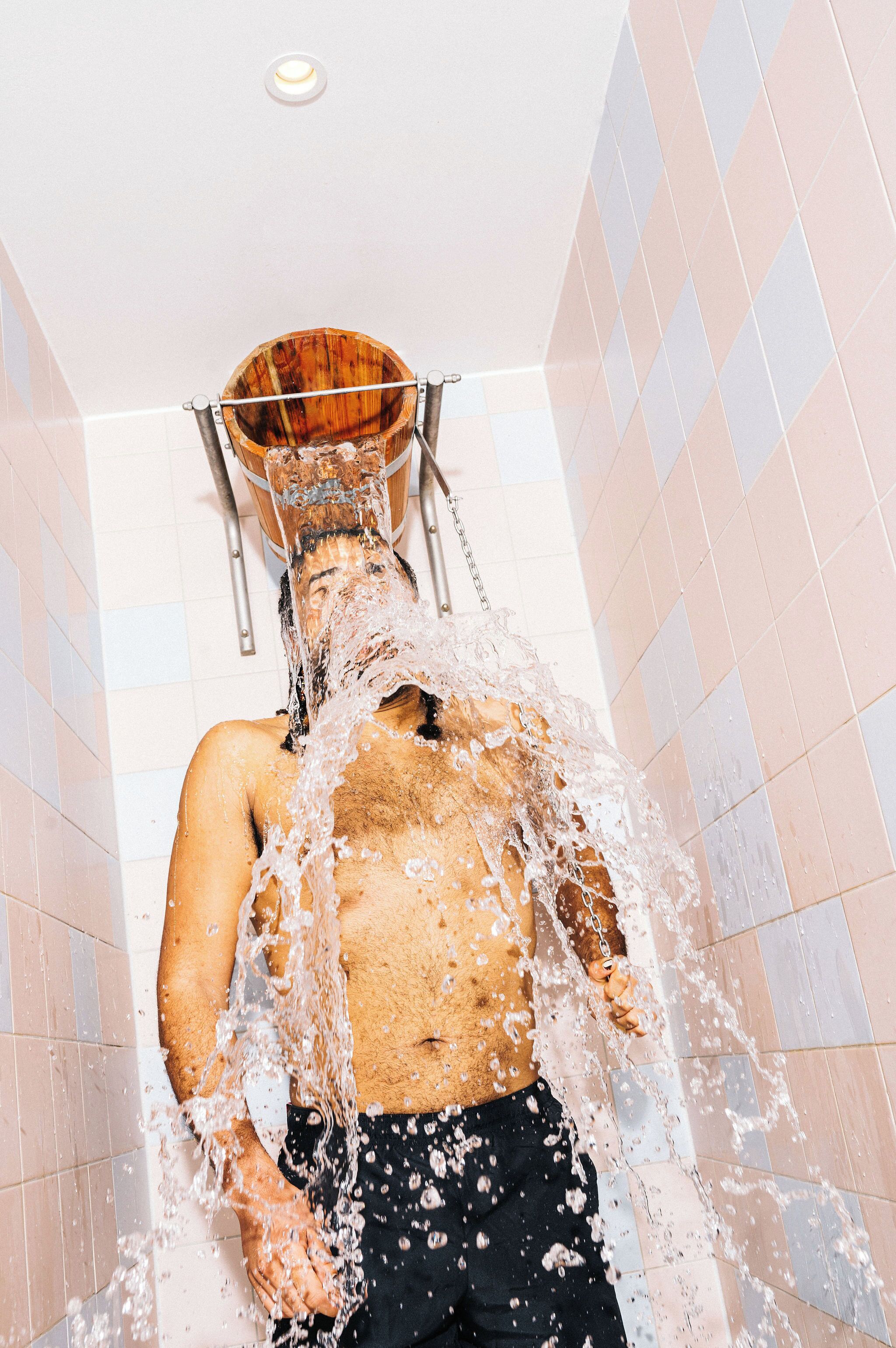 A person in a shower with water flowing over them.